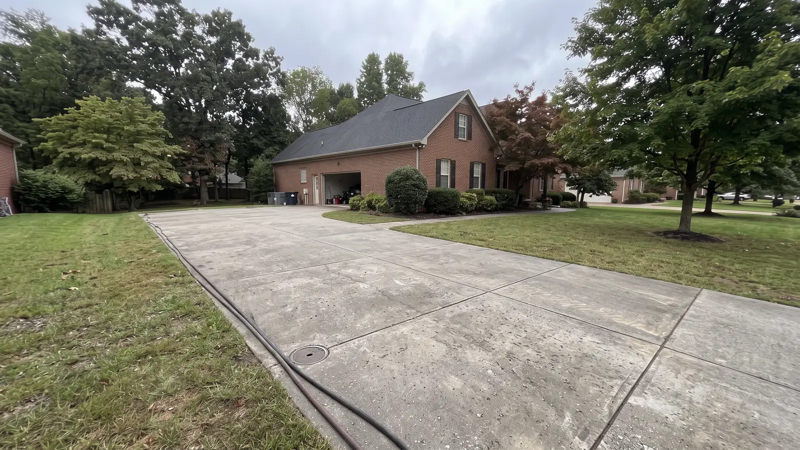 After: the same driveway intact with only a small access cover
